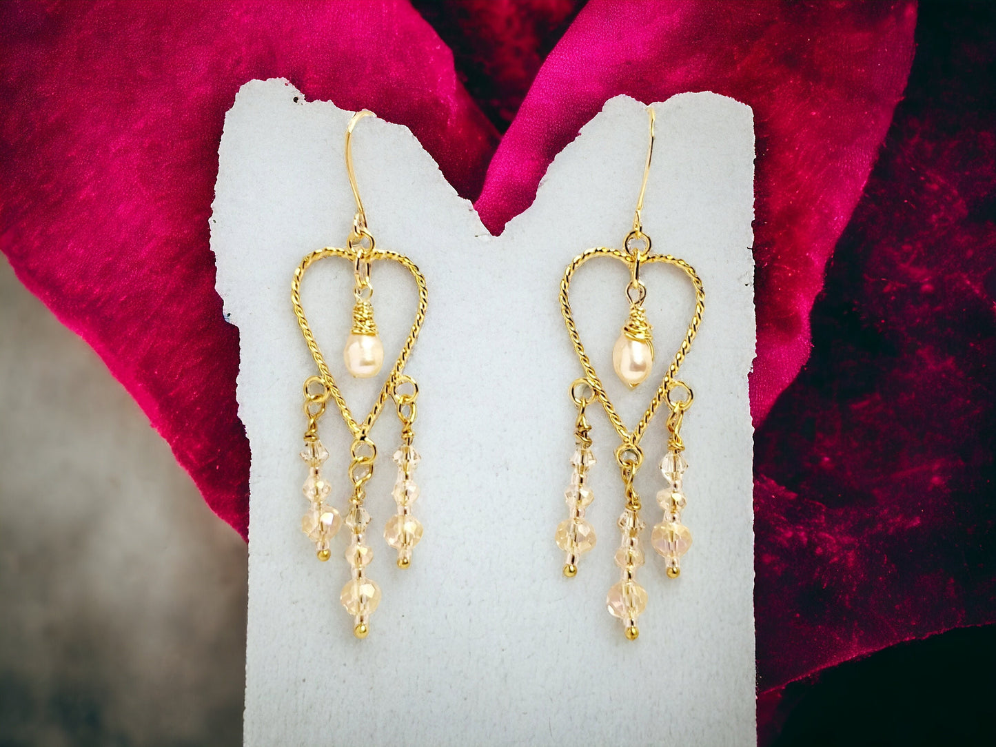 Cultured freashwater peach pearls set on Gold twisted heart chandelier earrings