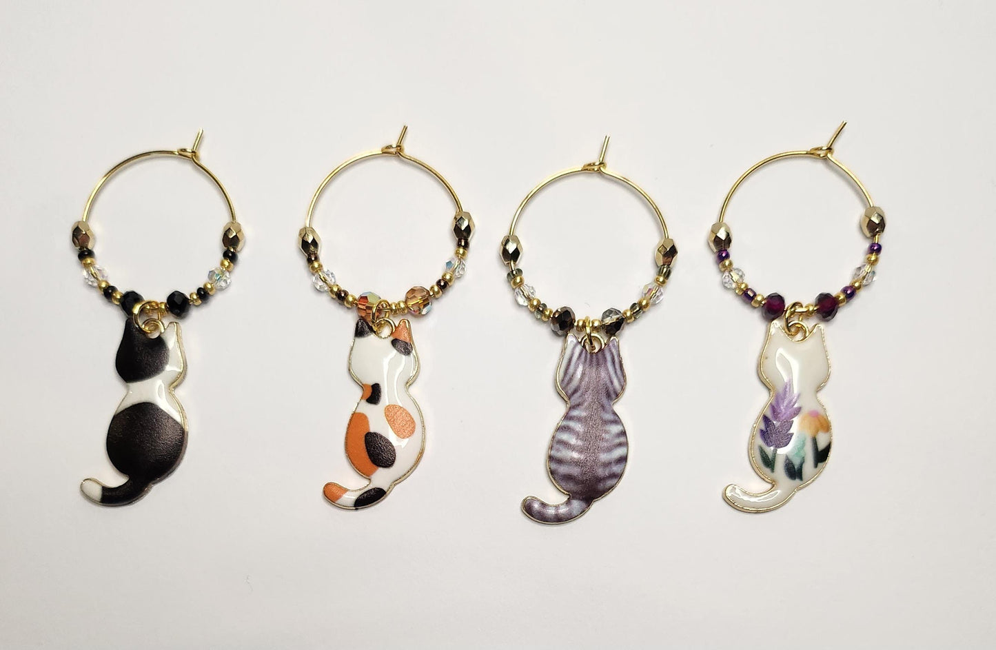 Cat wine charms with crystal embellishments-Set of 4 gold plated wine charms with a calico, tabby, blk/white and blue/wht porcelain designs