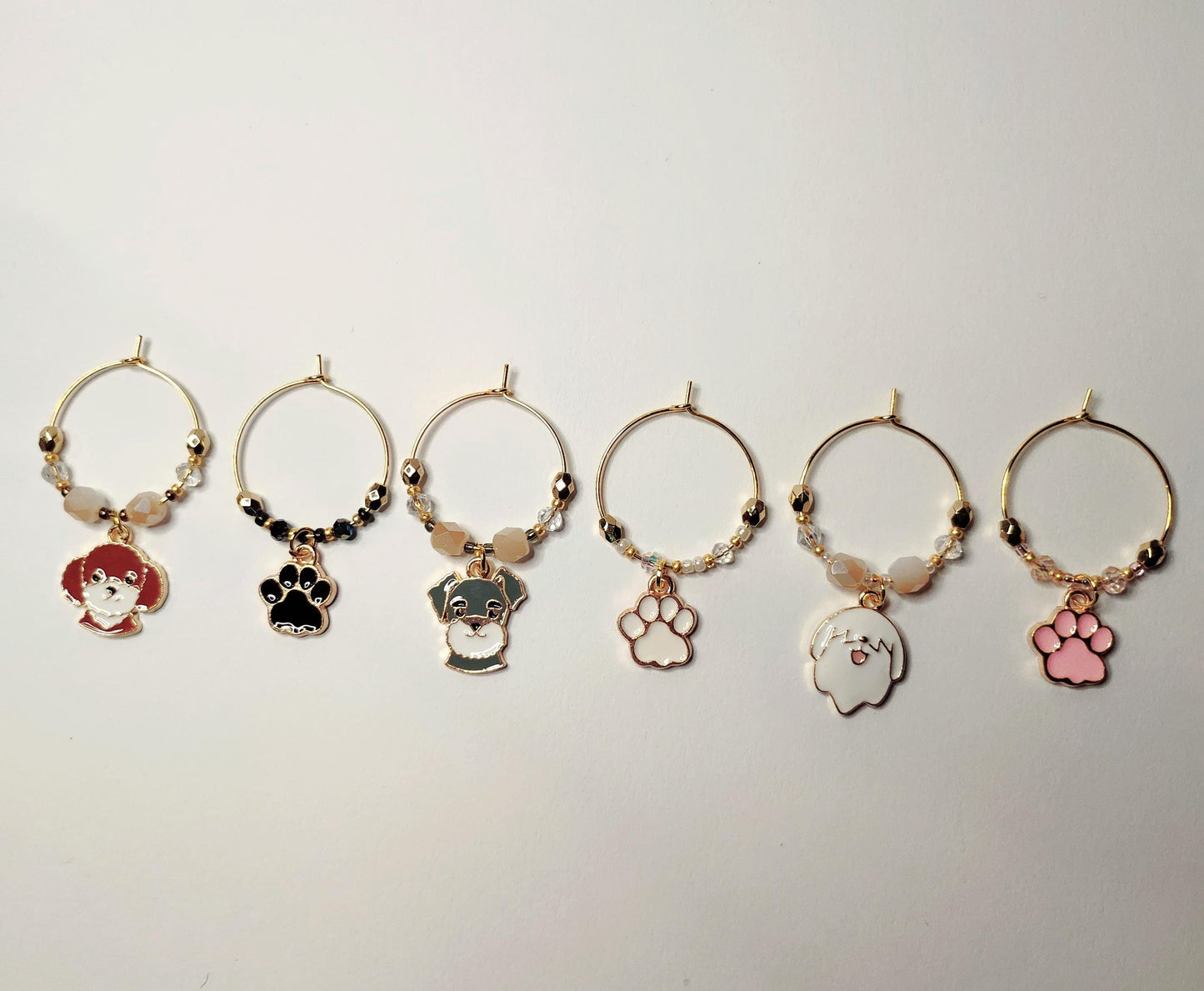 Dog wine charms with crystal embellishments-Set of 6 gold plated wine charms with three dogs and three paw prints.