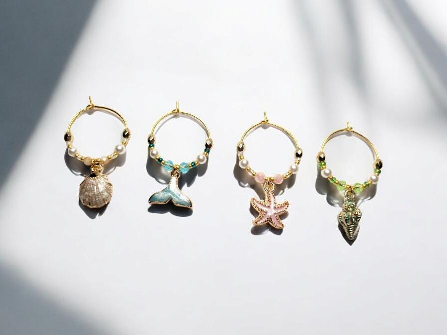 Mermaid Ocean theme enamel Wine charms, set of 4 in pastels white, blue, pink and green on gold plated holders.