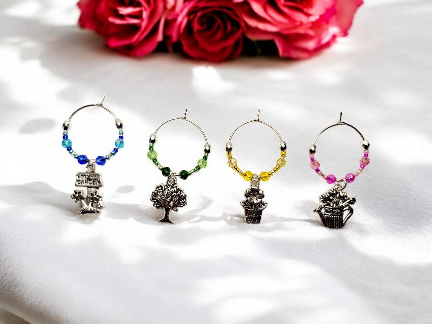 Garden themed wine charms, set of 4 on silver plated holders, with crystal beading in blue, green, yellow and pink.