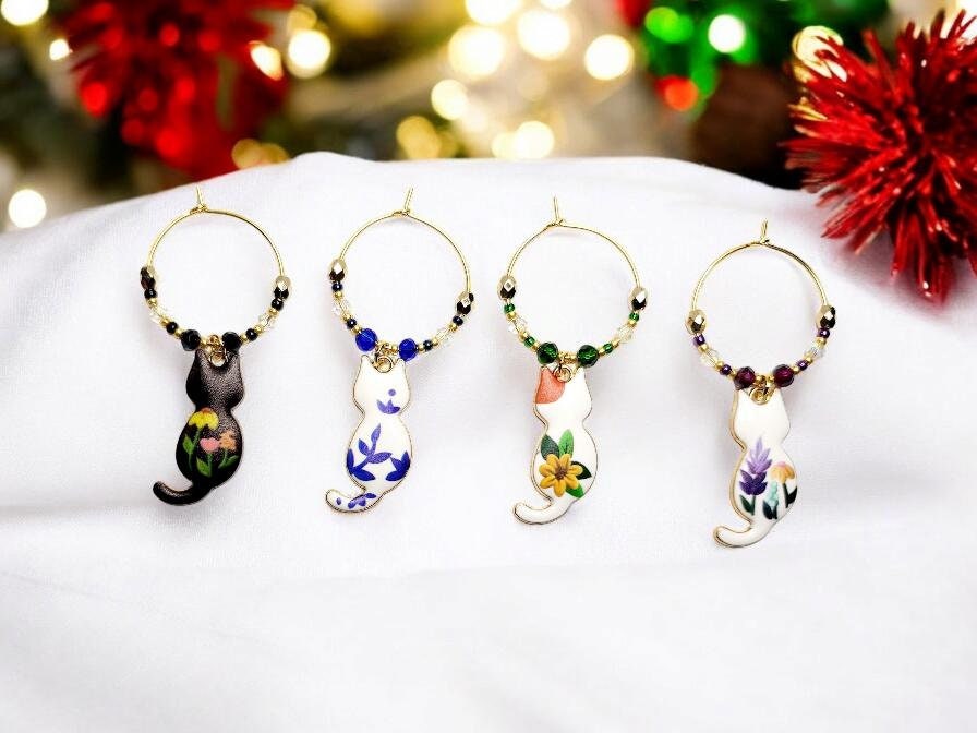 Cat wine charms with crystal embellishments-Set of 4 gold plated wine charms with different painted floral designs on each.