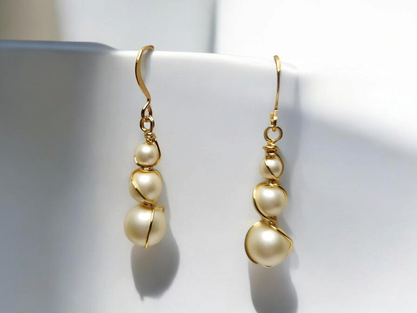 Three pearl and gold handcrafter dangle earrings