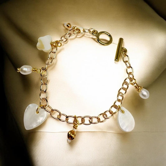 Mother of Pearl Charms and Natural pearls set on gold tone charm bracelet