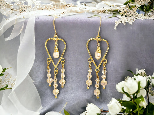 Cultured freashwater peach pearls set on Gold twisted heart chandelier earrings