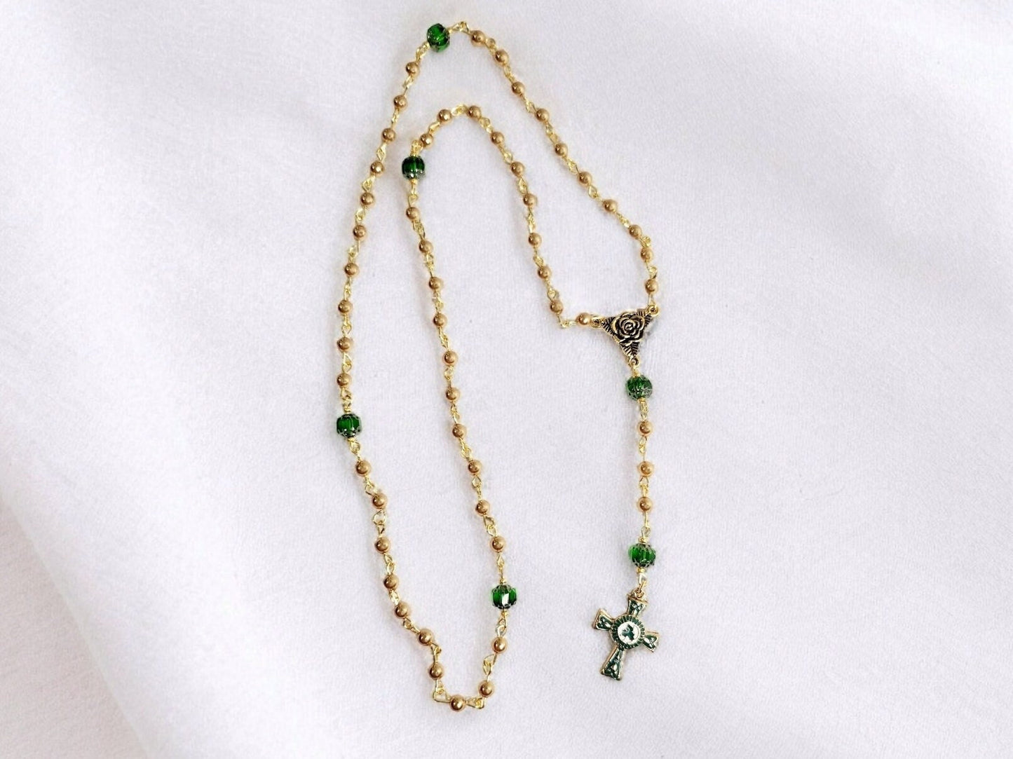 Handmade Gold and Green czech glass beaded rosary with gold trinity rose connector and white, green and gold enameled Celtic cross.