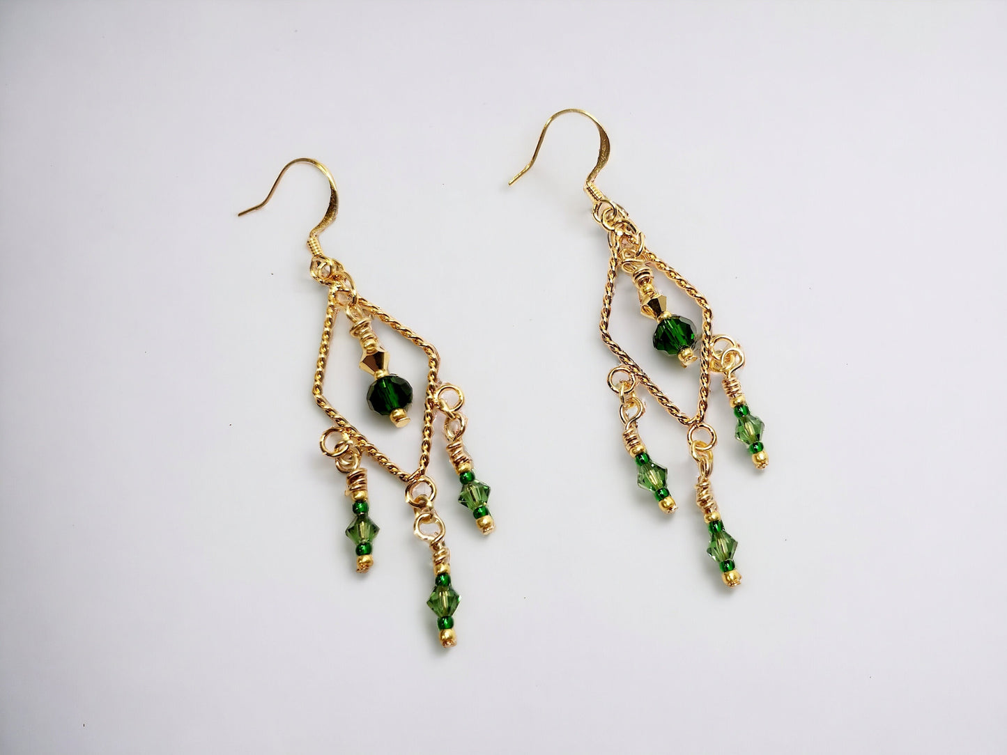 Gold twisted triangle chandelier earrings with emerald beading