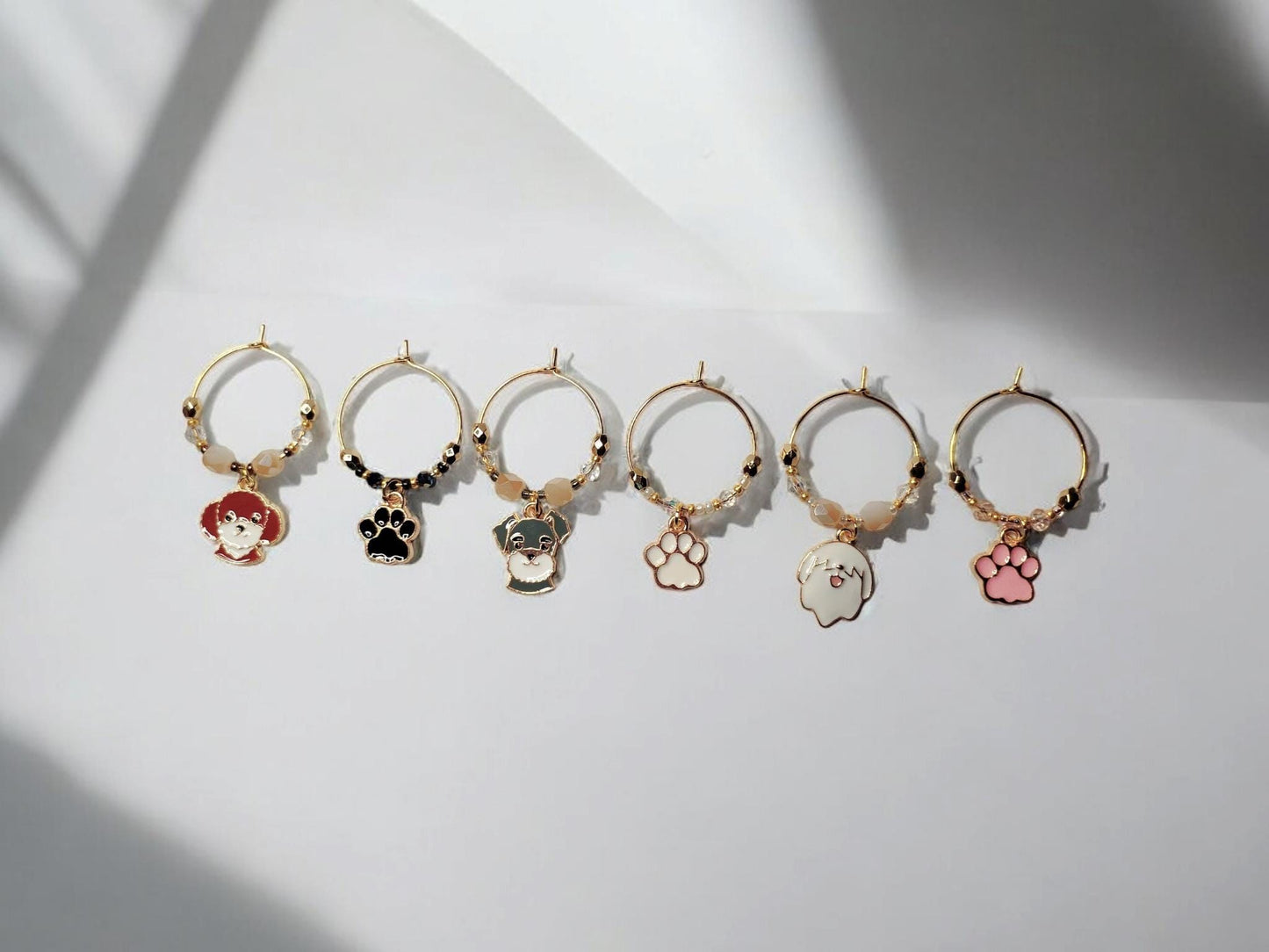 Dog wine charms with crystal embellishments-Set of 6 gold plated wine charms with three dogs and three paw prints.