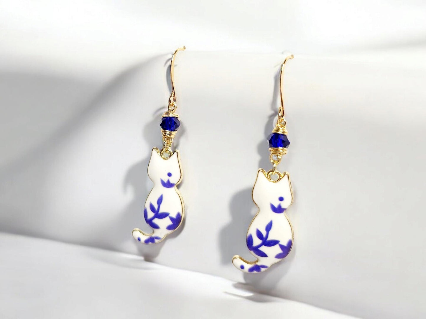 White and blue porcelian themed cat charm dangle earrings with blue beading