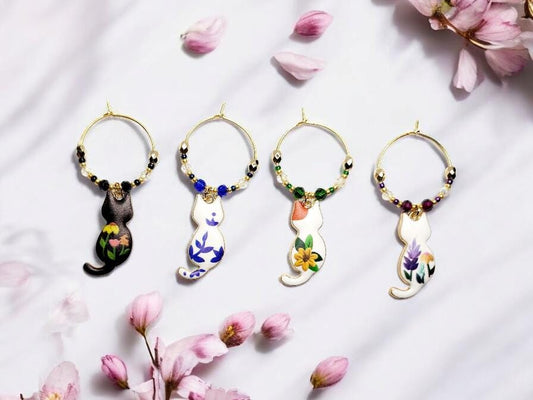 Cat wine charms with crystal embellishments-Set of 4 gold plated wine charms with different painted floral designs on each.