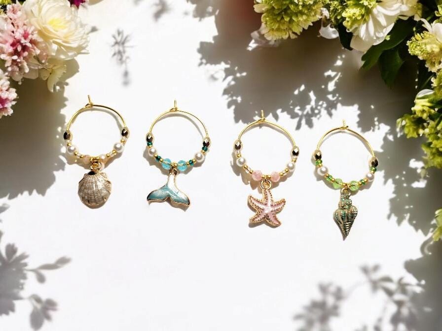 Mermaid Ocean theme enamel Wine charms, set of 4 in pastels white, blue, pink and green on gold plated holders.