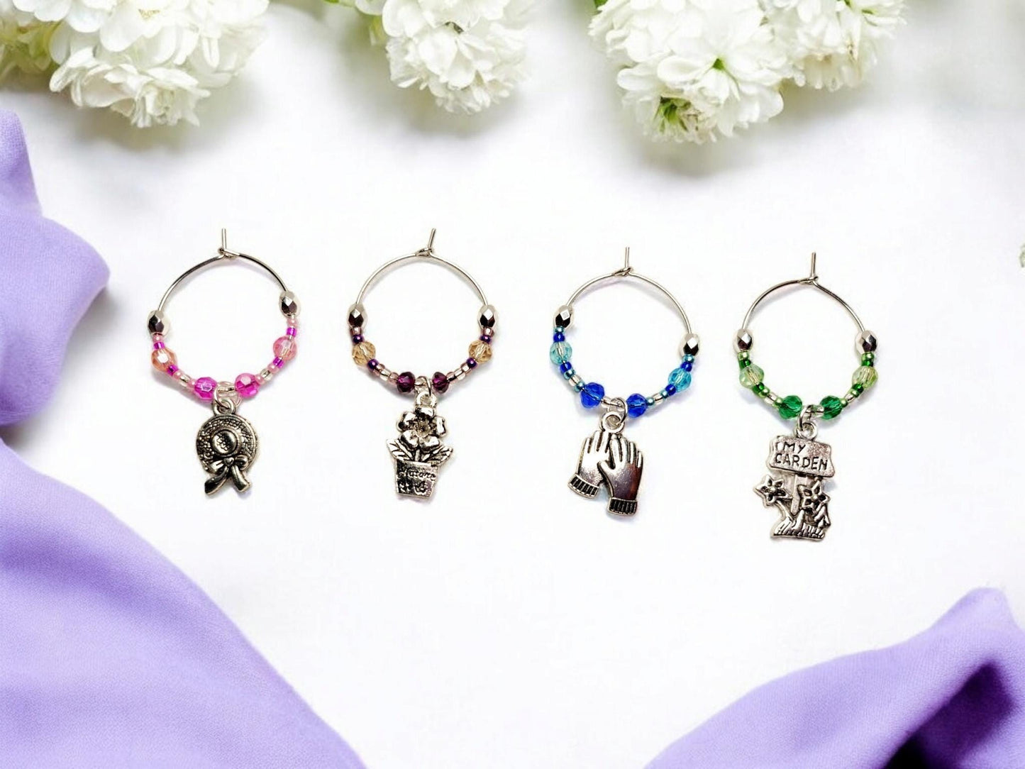 Garden themed wine charms, set of 4 on silver plated holders, with crystal beading in pink, purple, blue and green.