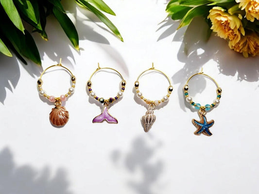 Mermaid Ocean theme enamel Wine charms, set of 4 in of salmon pink, purple, white and blue.