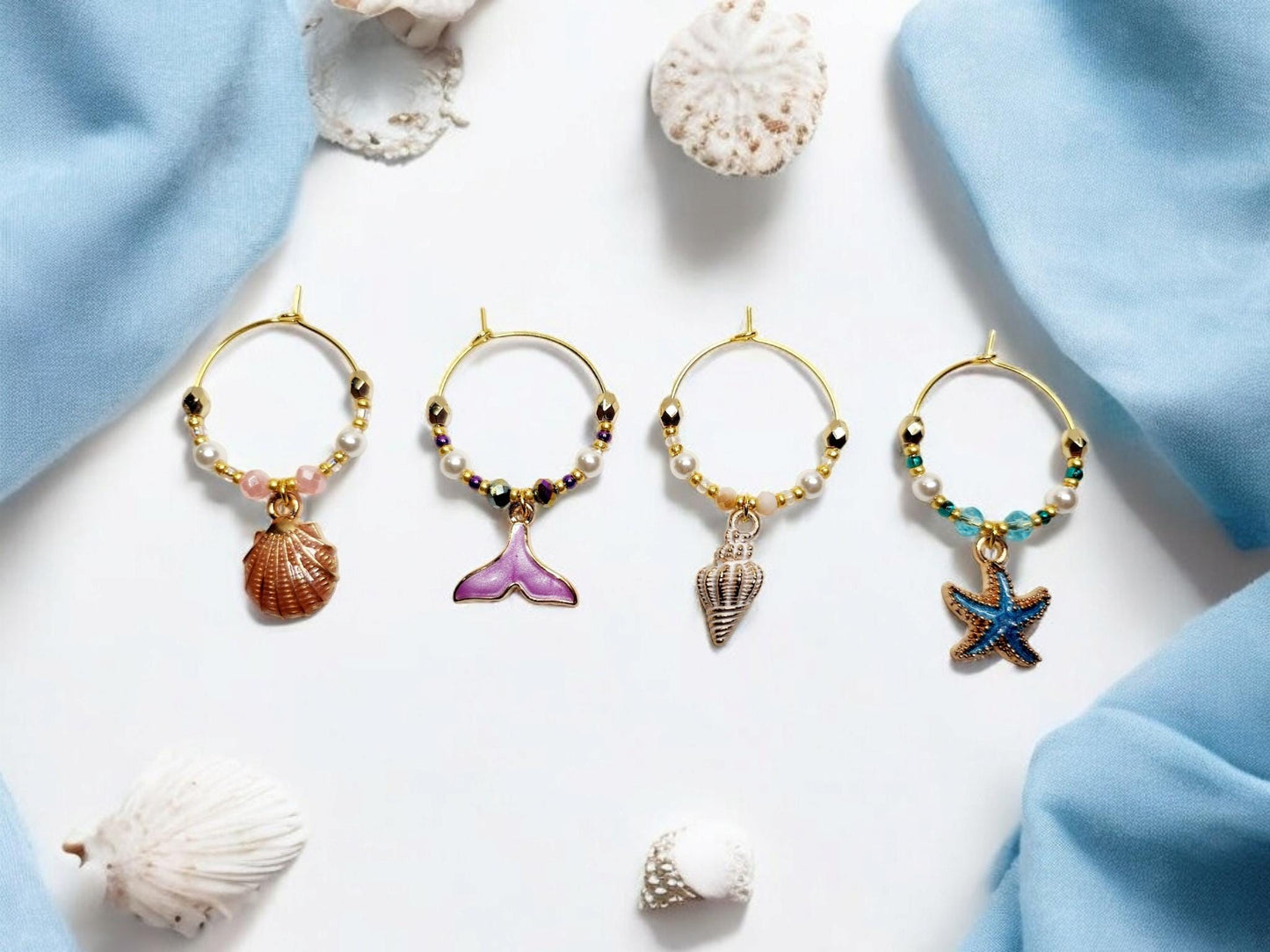 Mermaid Ocean theme enamel Wine charms, set of 4 in of salmon pink, purple, white and blue.