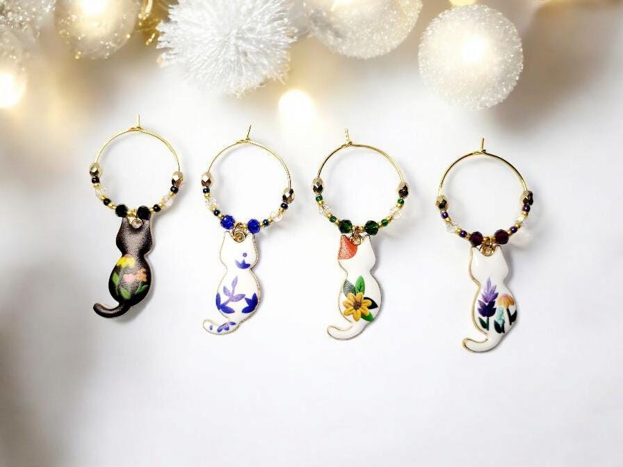 Cat wine charms with crystal embellishments-Set of 4 gold plated wine charms with different painted floral designs on each.