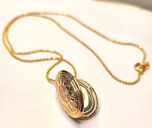 Gold oval locket set on 18inch gold beaded chain
