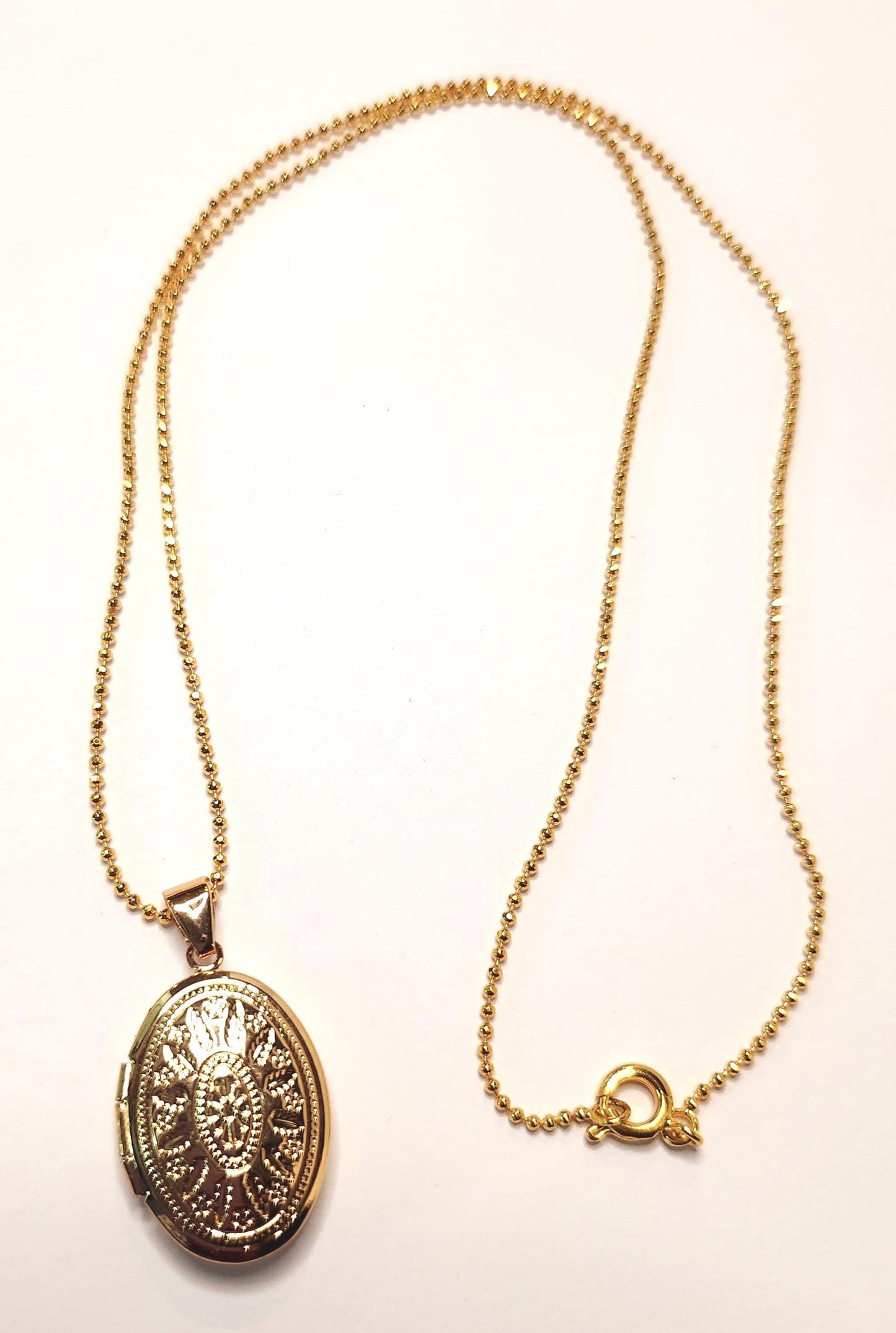 Gold oval locket set on 18inch gold beaded chain