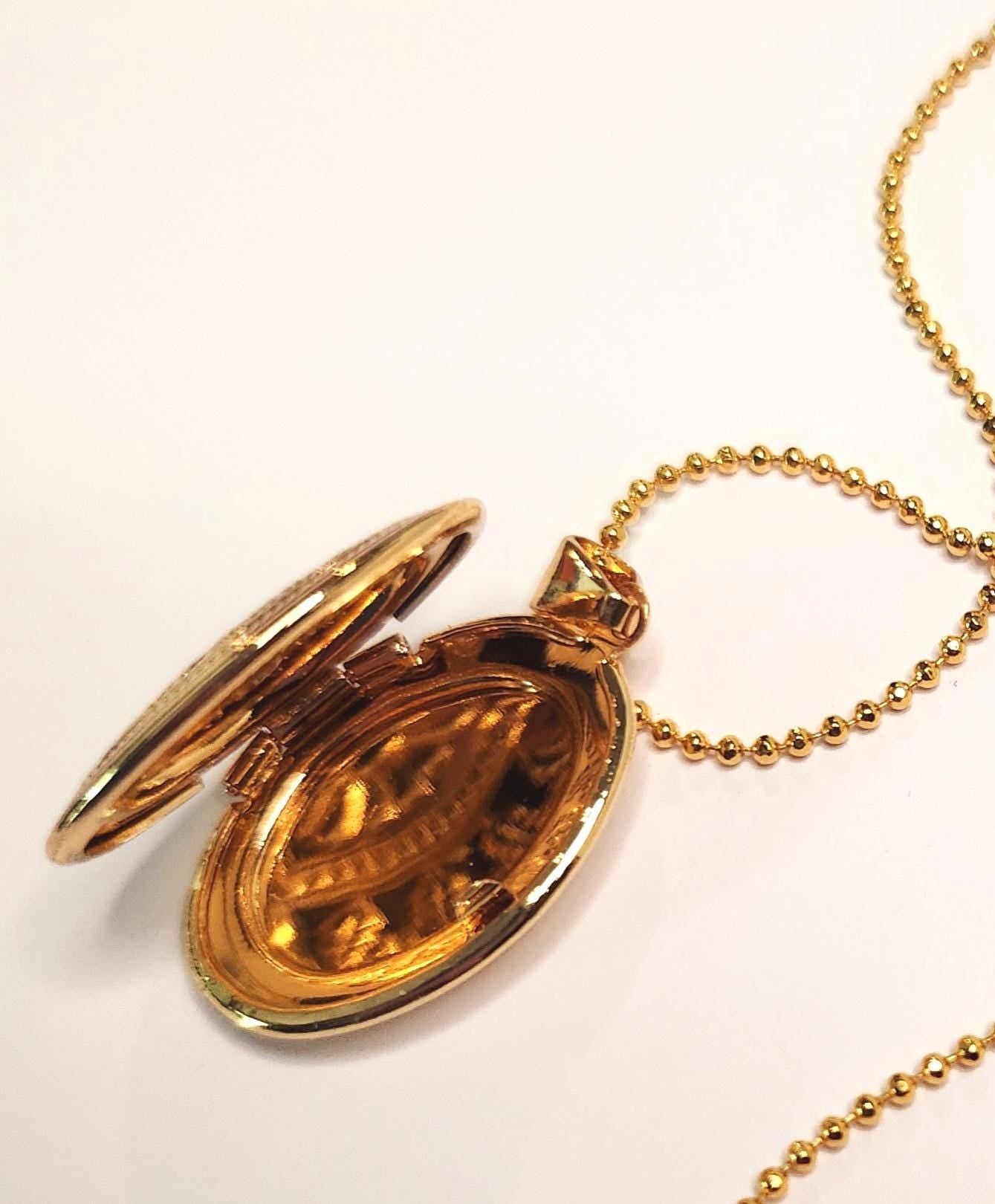 Gold oval locket set on 18inch gold beaded chain