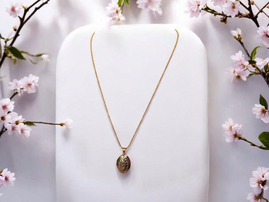 Gold oval locket set on 18inch gold beaded chain