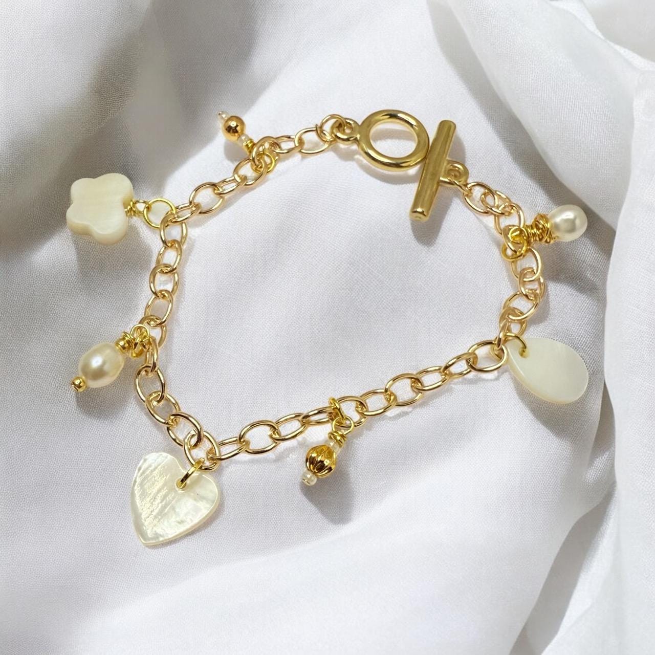 Mother of Pearl Charms and Natural pearls set on gold tone charm bracelet