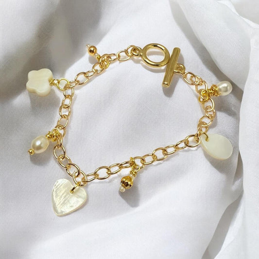 Mother of Pearl Charms and Natural pearls set on gold tone charm bracelet
